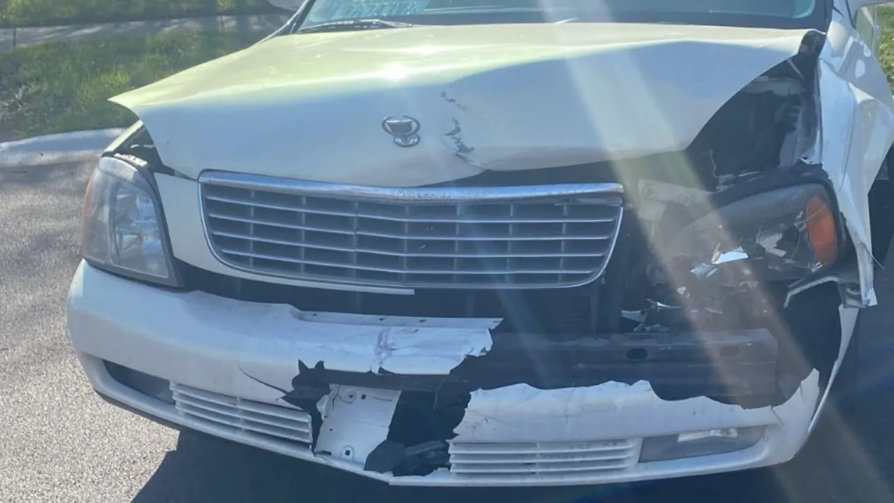 White sedan with a crushed front bumper and a broken headlight.